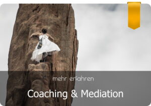 eine Frau in einem weißen Kleid klettert einen Felsen hinauf - Coaching und Mediation